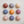 Nine colorful marble-like ceramic balls arranged in a 3x3 grid on a light background.