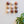 Nine spherical ceramic domes on a light surface with a plant leaf in the corner